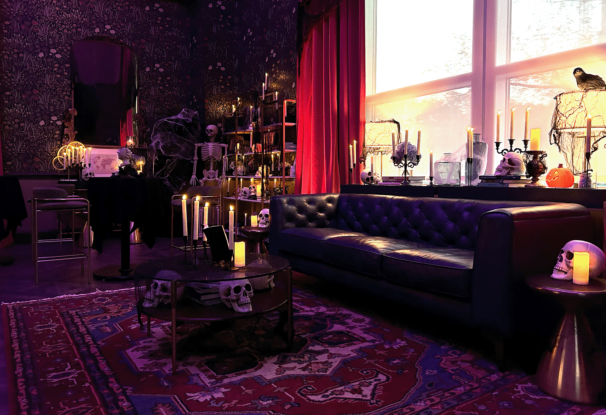 a photo of a couch and coffee table the table has skulls and candles on it