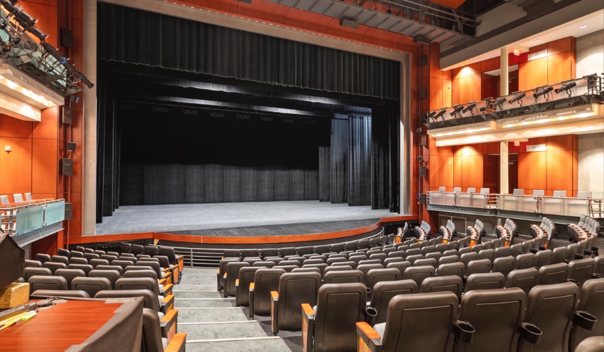 Interior view of A.J. Fletcher Opera Theater showing stage and tiered seating with balcony seats visible. 