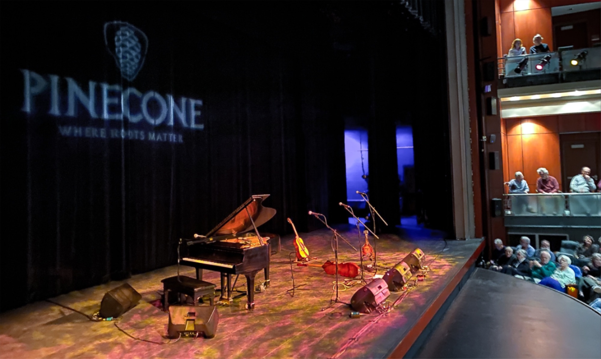 A photo of a stage with a piano and instruments on it set for a performance there are no people shown