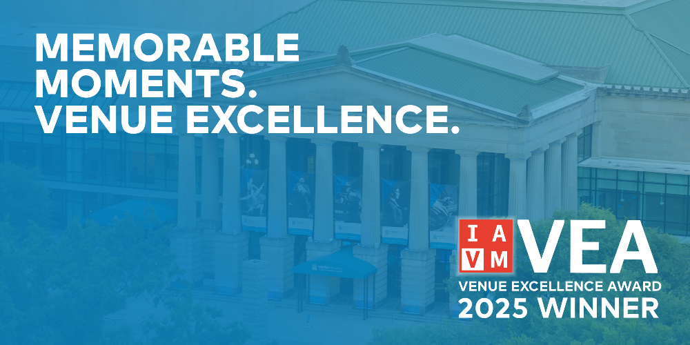 A graphic with a blue overlay showing the words memorable moments venue excellence and iavm venue excellence award winner in the background is a photo of the performing arts center