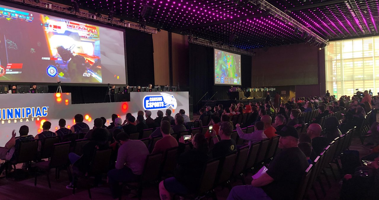 large group of people in a dark room competing in esports