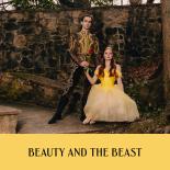 Photo of female dancer in yellow dress and male dancer in historical ballet costume in front of stone wall