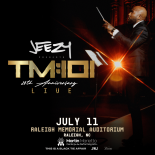Jeezy conducting an orchestra in a nice suit with a dark background