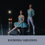 Photo of a male and female dancer onstage in traditional ballet costuming