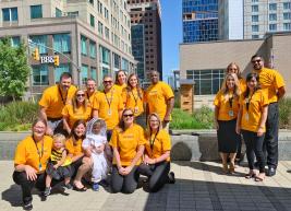 Members of our team are posing arounf the new bee hive at the Raleigh Convention Center in matching "Bee Day" tshirts