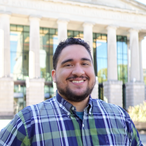 a photo of EG Garcia he has on a plaid button down shirt