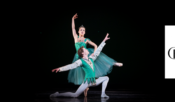 to dancers are seen with their arms stretched in the air the Carolina Ballet logo is shown on the right side