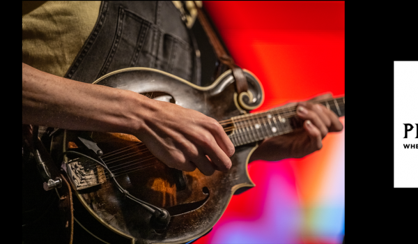 an unclose  photo of a mandolin player the pinecone logo is also shown in the right side